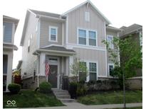 Charming two-story home with neutral siding, a welcoming porch, and a well-manicured front lawn at 5755 Buskirk Dr, Indianapolis, IN 46216