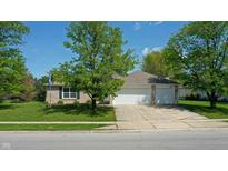 Charming single-story brick home with a well-manicured lawn and a spacious two-car garage at 6190 E Ayrshire Cir, Camby, IN 46113