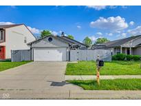 Charming home featuring a well-maintained lawn, attached garage and a traditional mailbox at 6707 Greendale Ln, Indianapolis, IN 46241