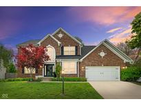 Charming two-story brick home with a well-manicured lawn and attached two car garage at 828 Breaside Ln, Greenwood, IN 46143