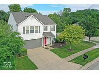 Well-maintained two-story home featuring a lovely front yard, attached garage, and mature trees at 10316 Hatherley Way, Fishers, IN 46037