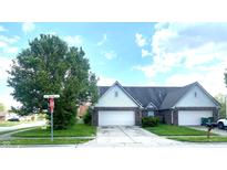 Charming home featuring a two-car garage and well-maintained front yard with a beautiful tree at 1081 Torino Ln, Franklin, IN 46131