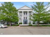 Attractive condo building with large columns and well-maintained landscaping and charming curb appeal at 12833 Tradd St # 1B, Carmel, IN 46032