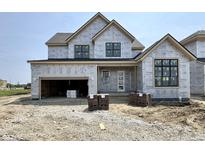 Two-story house featuring a garage, front door, and windows surrounded by construction materials at 1415 Beaumont Cir, Westfield, IN 46074
