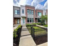 Beautiful townhouse with a manicured lawn and modern architectural details, creating a welcoming curb appeal at 1520 Central Ave, Indianapolis, IN 46202