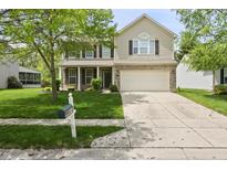 Charming two-story home with a well-manicured front yard and an attached two-car garage at 16001 Concert Way, Noblesville, IN 46060