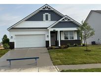 Charming two-story home featuring a two-car garage, manicured lawn, and classic architectural details at 2047 Quail W Dr, Danville, IN 46122