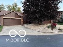 Charming home featuring a two-car garage, mature tree, and concrete driveway at 209 Brighton Ct, Greenwood, IN 46143