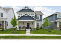 Charming two-story home with blue siding, stone accents, and a well-manicured lawn at 2542 Barstow Dr, Whitestown, IN 46075