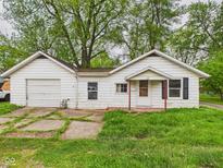 Charming single-story home with attached garage and covered entry on a lush lawn at 29 E Pine St, Anderson, IN 46012