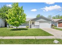 Charming single-story home with a well-maintained lawn and a mature tree in the front yard at 3022 Cameron St, Indianapolis, IN 46203