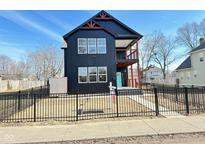 Modern two-story home with black siding, white trim, and a welcoming blue front door at 337 N Beville Ave, Indianapolis, IN 46201