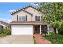 Charming two-story home featuring a two-car garage and a welcoming brick-lined walkway leading to the front door at 4316 Village Trace Dr, Indianapolis, IN 46254