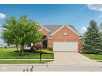 Charming brick home with a two-car garage and well-manicured lawn, enhancing curb appeal at 542 Hadleigh Ct, Westfield, IN 46074