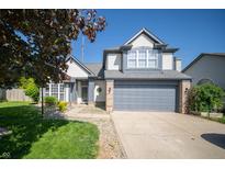 Charming two-story home with a two-car garage and well-manicured front yard at 5622 Mead Ct, Indianapolis, IN 46220