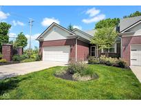 Charming brick home with a well-manicured lawn, lush landscaping, and attached two-car garage at 575 Dylan Dr, Avon, IN 46123