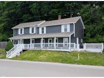 Charming two-story home features a welcoming front porch and beautifully landscaped yard at 689 N Main St, Martinsville, IN 46151