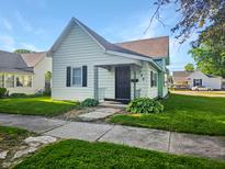 Charming home with a dark front door, manicured lawn and simple landscaping at 734 W North St, Lebanon, IN 46052
