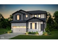 Charming two-story home with brick and siding, a two-car garage, and a beautifully landscaped front yard at 778 Adler Dr, Avon, IN 46123