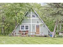 Charming A-frame home featuring a cozy front deck and lush greenery, perfect for outdoor relaxation at 809 Iron Bridge Rd, Cicero, IN 46034