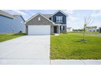 Charming two-story home with a wide driveway, a well-manicured lawn, and inviting curb appeal at 1181 Galaxy Ln, Danville, IN 46122