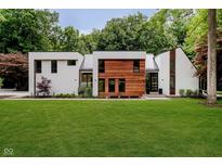 Modern two-story home featuring a beautifully landscaped lawn and mixed material exterior at 11911 Eden Glen Dr, Carmel, IN 46033