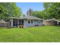 Charming single story home featuring a well maintained lawn and flower boxes under the windows at 1245 Kessler Blvd E Dr, Indianapolis, IN 46220