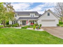 Charming two-story home with a manicured lawn and welcoming front porch adorned with patriotic decor at 14809 Senator Way, Carmel, IN 46032