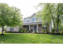 Charming two-story home with well-manicured lawn, featuring brick accents and lush landscaping at 16579 Lakeville Xing, Westfield, IN 46074
