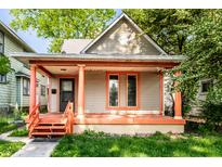 Charming home featuring a covered porch with orange columns and freshly painted trim accents at 2114 Sugar Grove Ave, Indianapolis, IN 46202