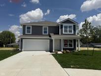 Two-story home featuring a two-car garage, manicured lawn and traditional architectural details at 24391 Stout St, Sheridan, IN 46069