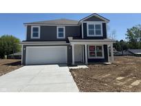 Charming two-story home with a two-car garage and freshly poured concrete driveway at 24391 Stout St, Sheridan, IN 46069