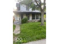 Two story home with covered porch and lawn at 2534 Carrollton Ave, Indianapolis, IN 46205