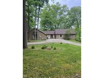 Charming stone house on a sprawling lot with a circular driveway and mature trees at 3692 Whippoorwill Lake S Dr, Monrovia, IN 46157