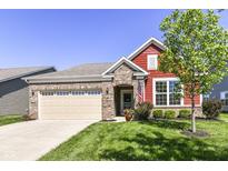 Charming single-story home with brick and red siding, an attached garage, and manicured lawn on a sunny day at 4039 Amaryllis Dr, Plainfield, IN 46168