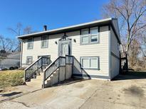Two-story home featuring neutral siding, dark trim, and a concrete driveway for convenient parking at 4144 Richelieu Rd, Indianapolis, IN 46226