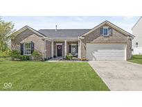 Charming brick home featuring a well-manicured lawn and an attached two-car garage at 5622 Hare Dr, Noblesville, IN 46062