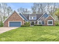 Charming brick home with a well-manicured lawn and attached two-car garage at 5948 Ridge Hill Way, Avon, IN 46123