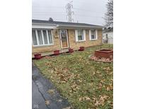 Charming brick home with a well-manicured lawn and inviting entryway at 6209 Meadowlark Dr, Indianapolis, IN 46226
