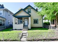 Charming two-story home with a fenced yard and welcoming front porch at 623 Orange St, Indianapolis, IN 46203