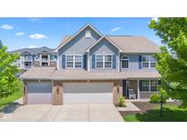 Charming two-story home with a three car garage, blue shutters and beautiful curb appeal at 8178 Eskerban Dr, Avon, IN 46123
