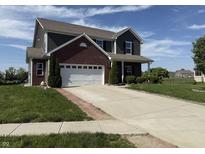 Two-story home with brick and siding, featuring an attached two-car garage and well-maintained front lawn at 928 Cherry Tree Ln, Greenwood, IN 46143