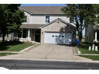 Two-story home featuring brick accents, a two-car garage, and a well-maintained lawn at 10773 Brighton Knoll S Pkwy, Noblesville, IN 46060