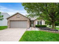 Charming brick home with a well-manicured lawn and beautiful landscaping at 12446 Deerview Dr, Noblesville, IN 46060