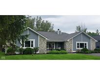 Charming single-story home featuring stone accents, gray siding, well-manicured lawn and covered porch at 12681 E 79Th St, Indianapolis, IN 46236