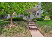 Charming home featuring a welcoming front porch, landscaped yard, and beautiful curb appeal at 13063 E 131St St, Fishers, IN 46037