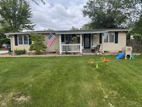Charming single-story home featuring a well-maintained lawn, landscaping, and a welcoming front porch at 1505 Apple St, Greenfield, IN 46140