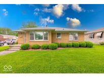 Charming single-story home features a well-maintained lawn and manicured shrubbery at 2150 Main St, Beech Grove, IN 46107