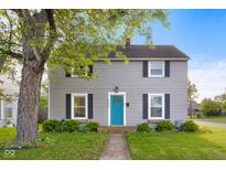 Charming two-story home with a manicured lawn, bright blue front door, and lovely landscaping at 2336 Sycamore St, Columbus, IN 47201