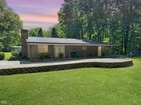 Ranch style home featuring a brick exterior, covered porch, and meticulously manicured lawn at 2548 N Letterman Rd, Paragon, IN 46166